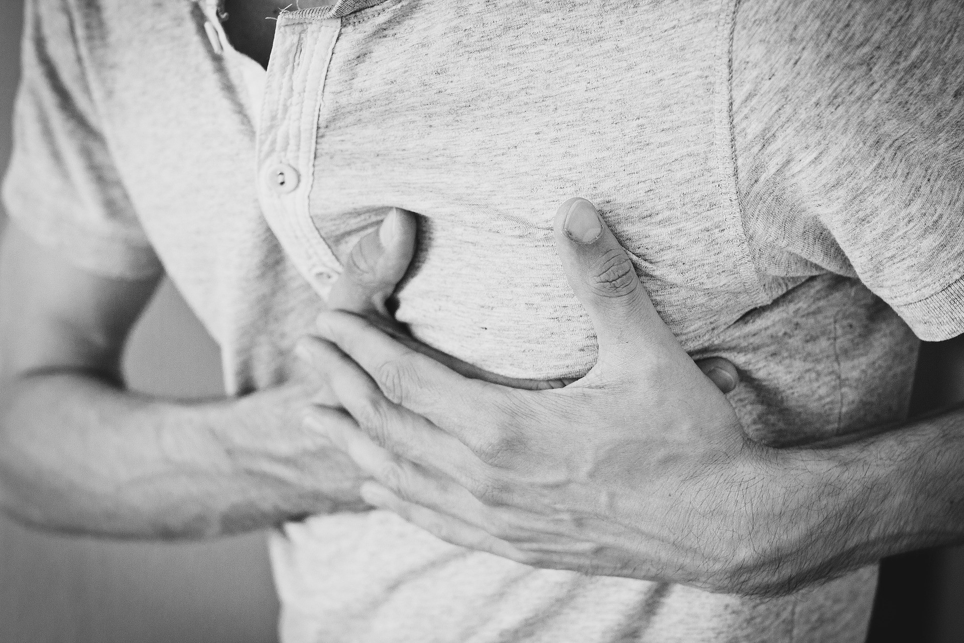 a man holding his chest in pain